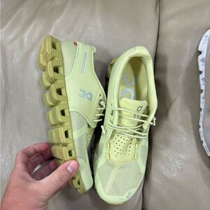 On Running Light Green Athletic Shoes with Mesh Upper and Unique Sole